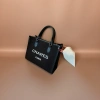 CHARES PARIS black handbag with white logo, black leather handle and beige sofa scene Specification image